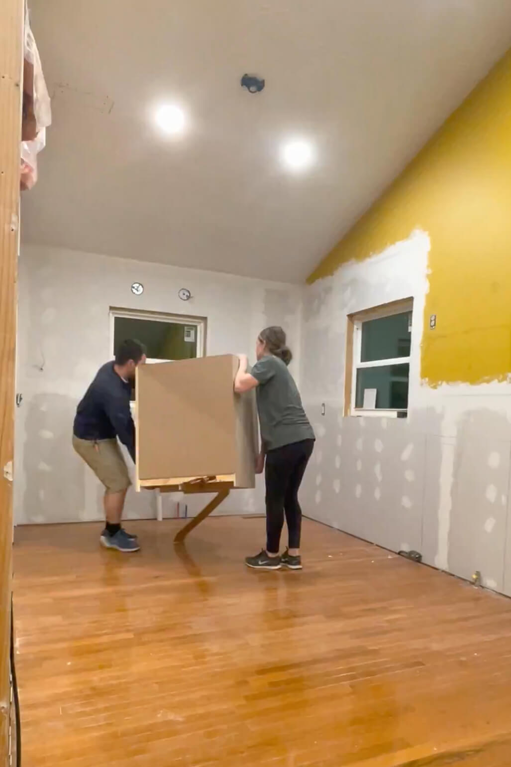 Installing stock cabinets during our DIY kitchen remodel.